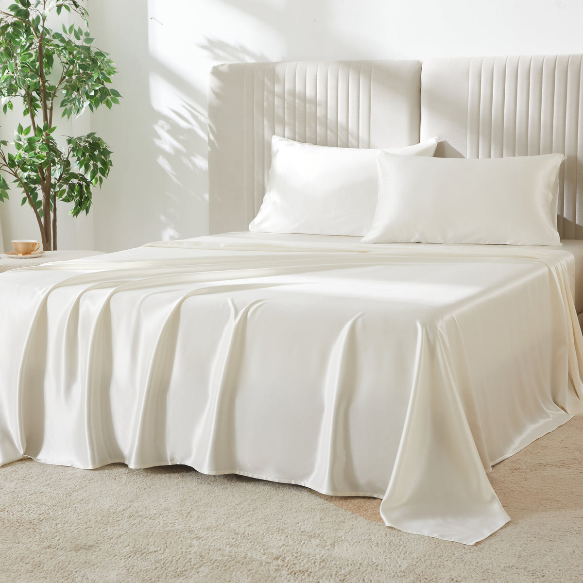 Elegant 22 Momme Silk Sheets Set in Ivory color displayed on a beautiful bed with 2 silk pillows