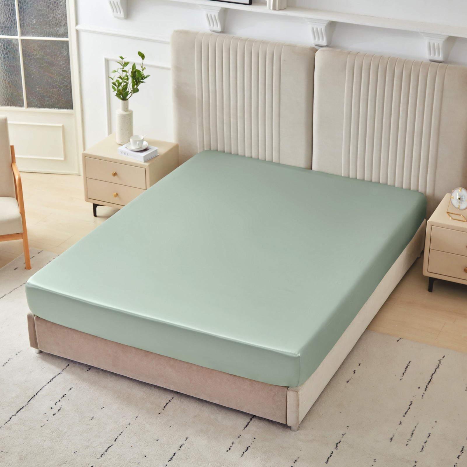 Mulberry Park Silks 22 Momme Silk Fitted Sheets in Sage on bed with upholstered headboard in a cozy bedroom setting