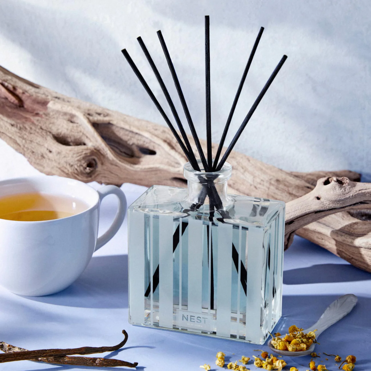 Nest New York’s Driftwood and Chamomile Reed Diffuser Lifestyle With Tea