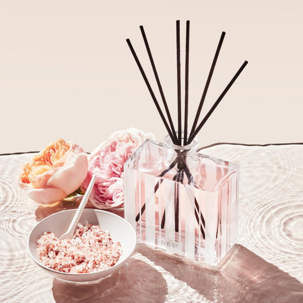 Nest New York Himalayan Salt &amp; Rosewater Reed Diffuser Lifestyle with Flowers on Counter