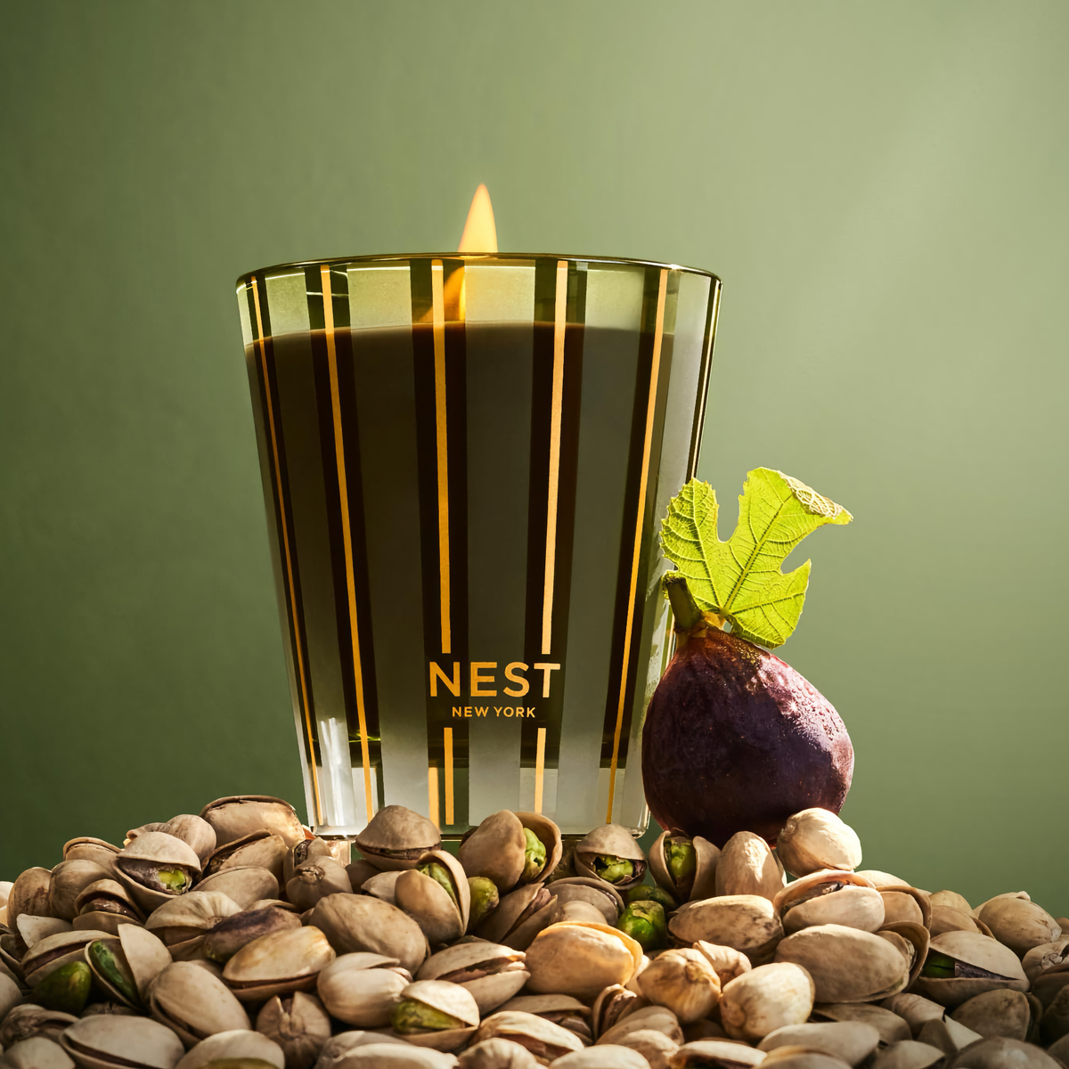 Nest New York Pistachio &amp; Wild Fig Classic Candle on Top of Pistachios and a Fig