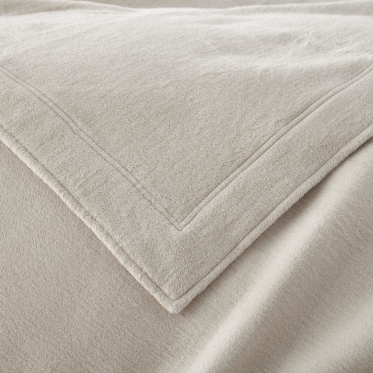 Corner View of Peacock Alley All Seasons Framed Blanket in Flint color