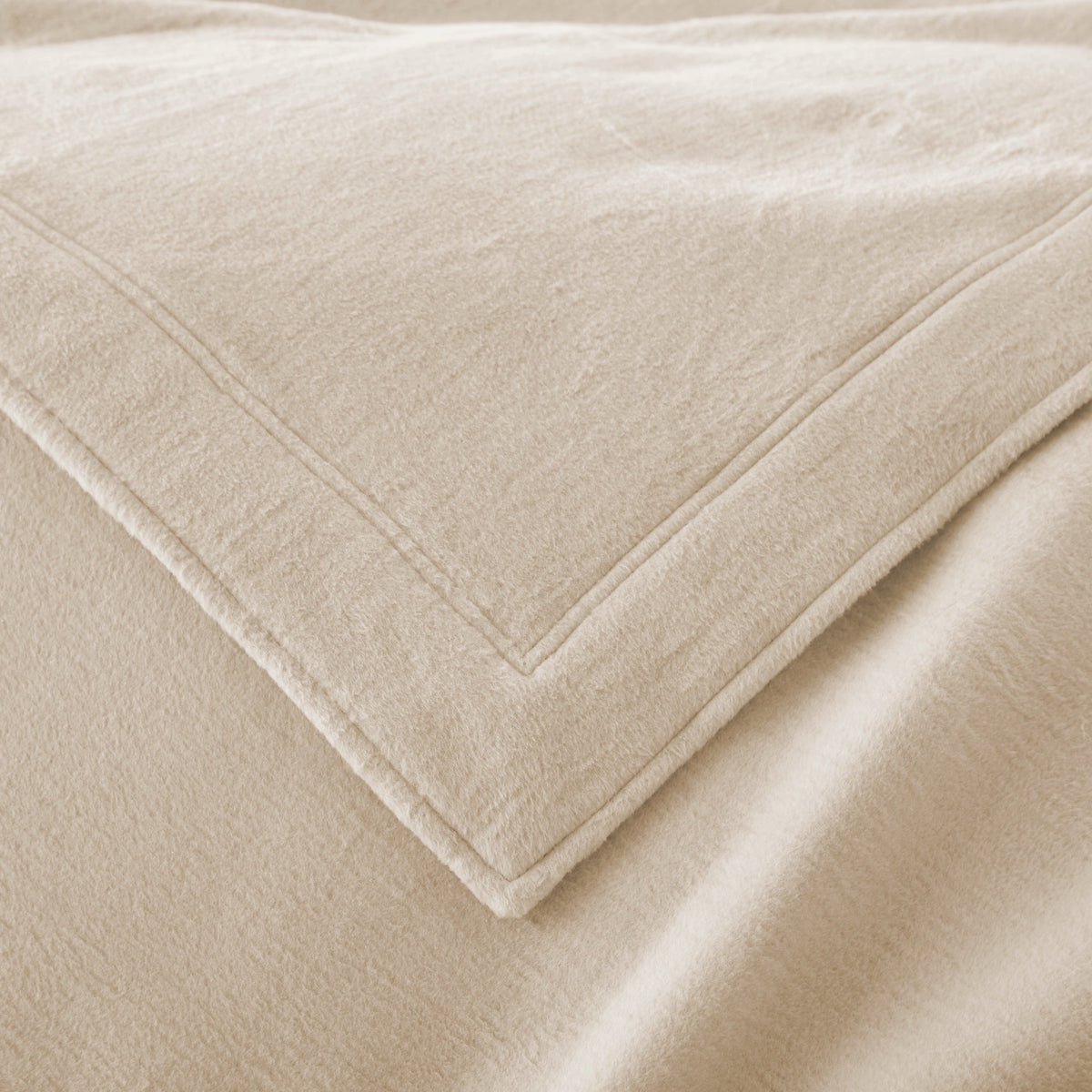 Corner View of Peacock Alley All Seasons Framed Blanket in Linen color