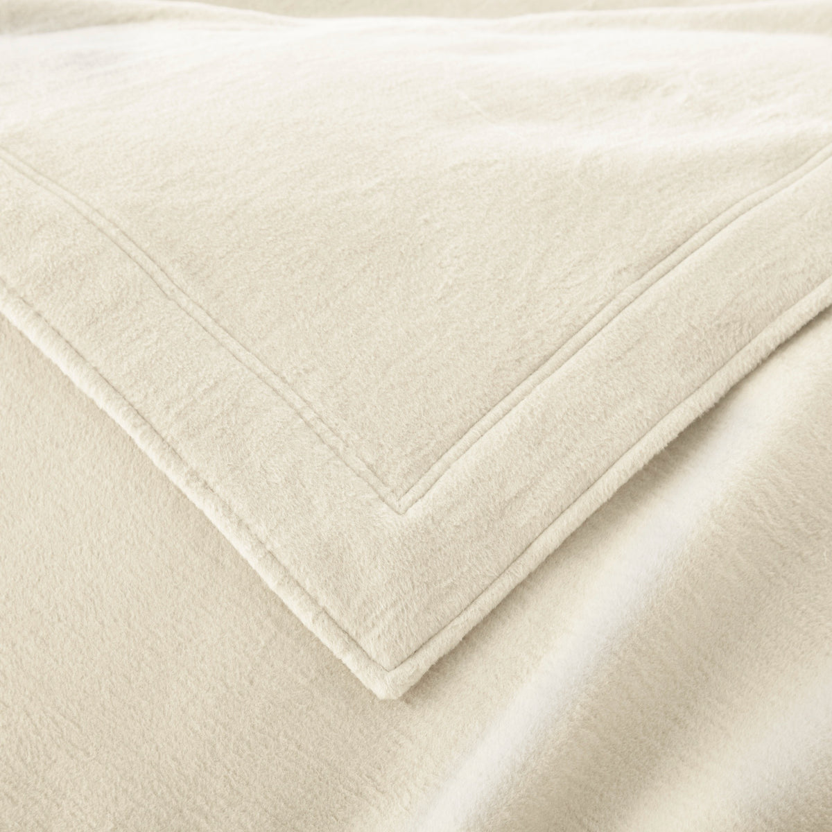 Corner View of Peacock Alley All Seasons Framed Blanket in Natural color