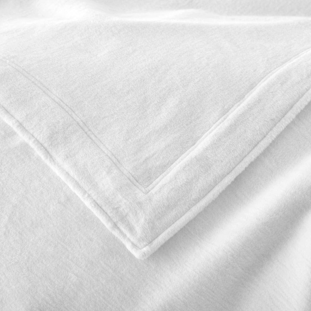 Corner View of Peacock Alley All Seasons Framed Blanket in White color