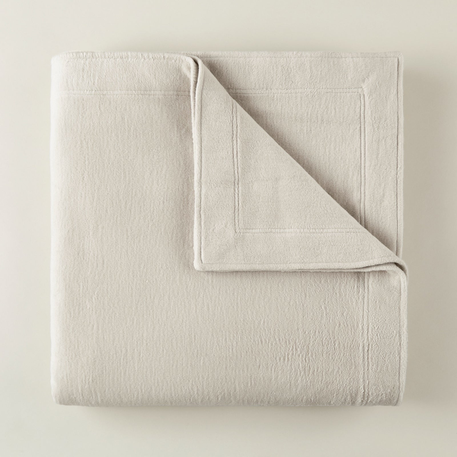 Folded Peacock Alley All Seasons Framed Blanket in Flint color