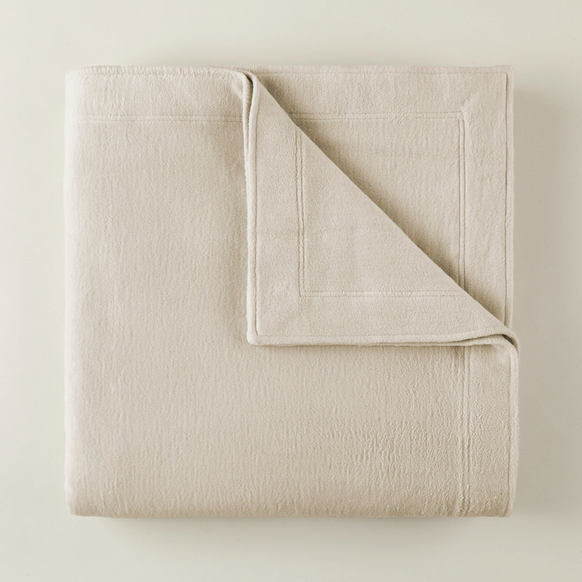 Folded Peacock Alley All Seasons Framed Blanket in Natural color