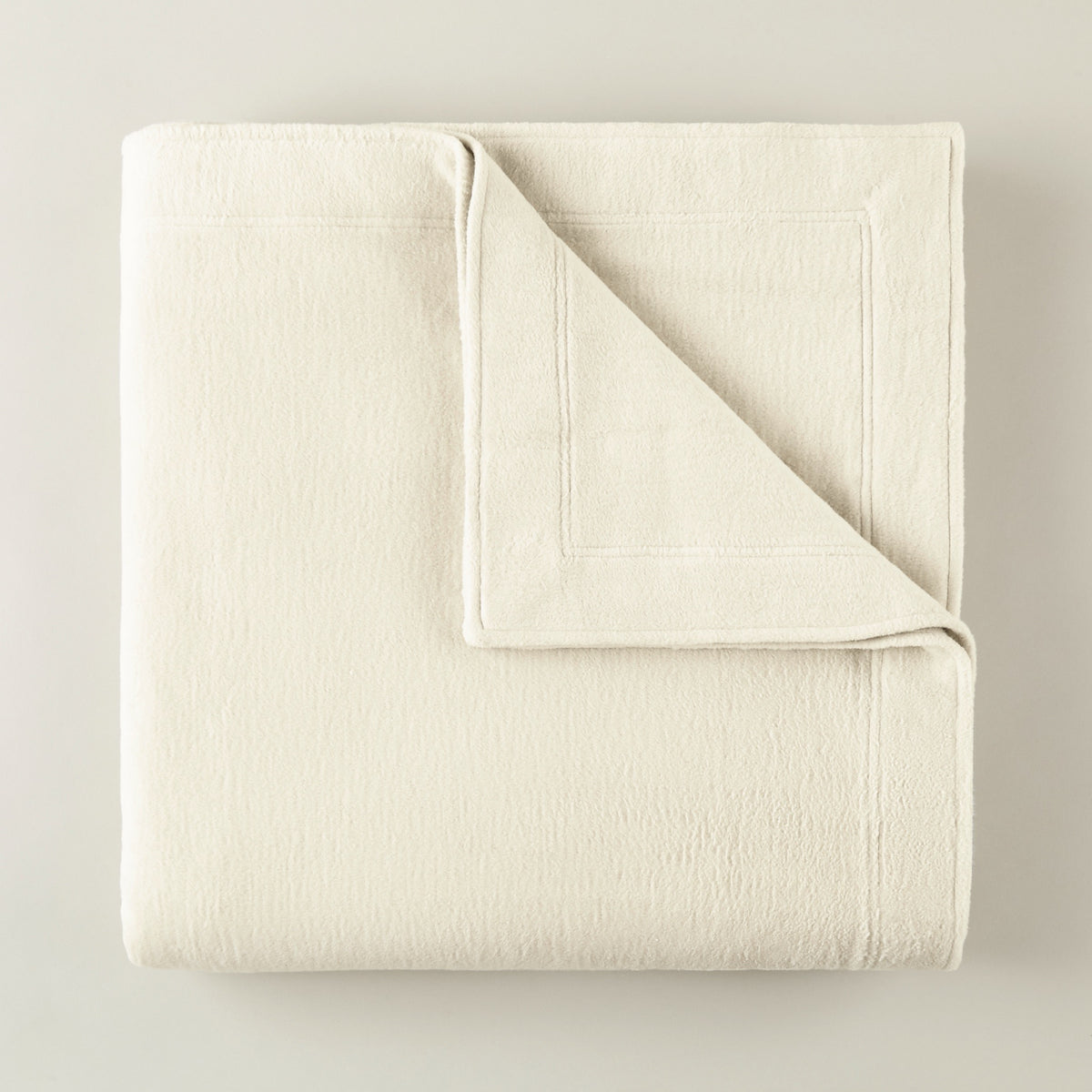 Folded Peacock Alley All Seasons Framed Blanket in Natural color