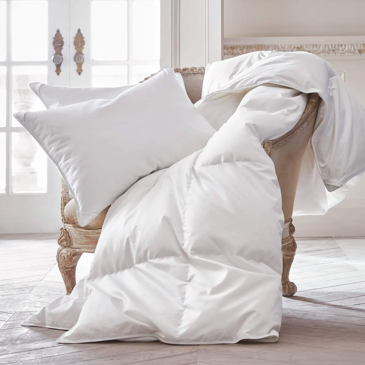 Peacock Alley Canadian White Down 700 Fill Power Duvet Inserts on a sofa