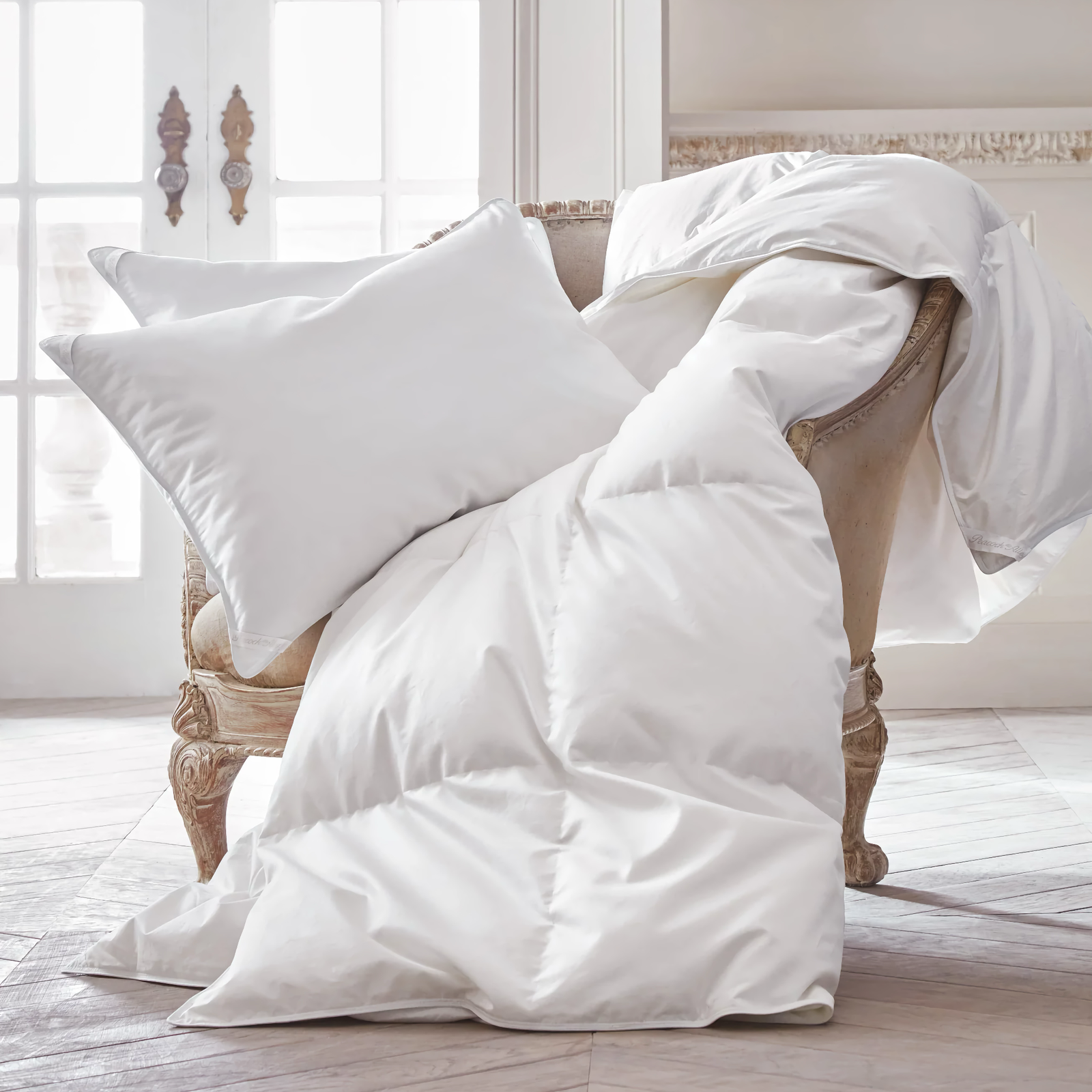 Peacock Alley Canadian White Down 700 Fill Power Duvet Inserts on a sofa