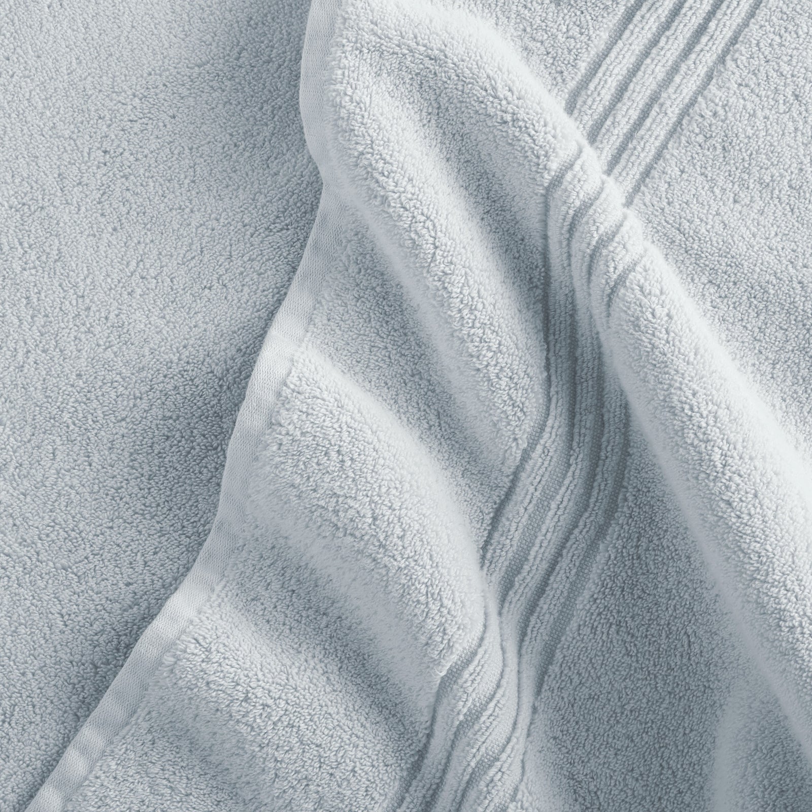 Stack of Peacock Alley Chelsea Bath Towels in Mist color