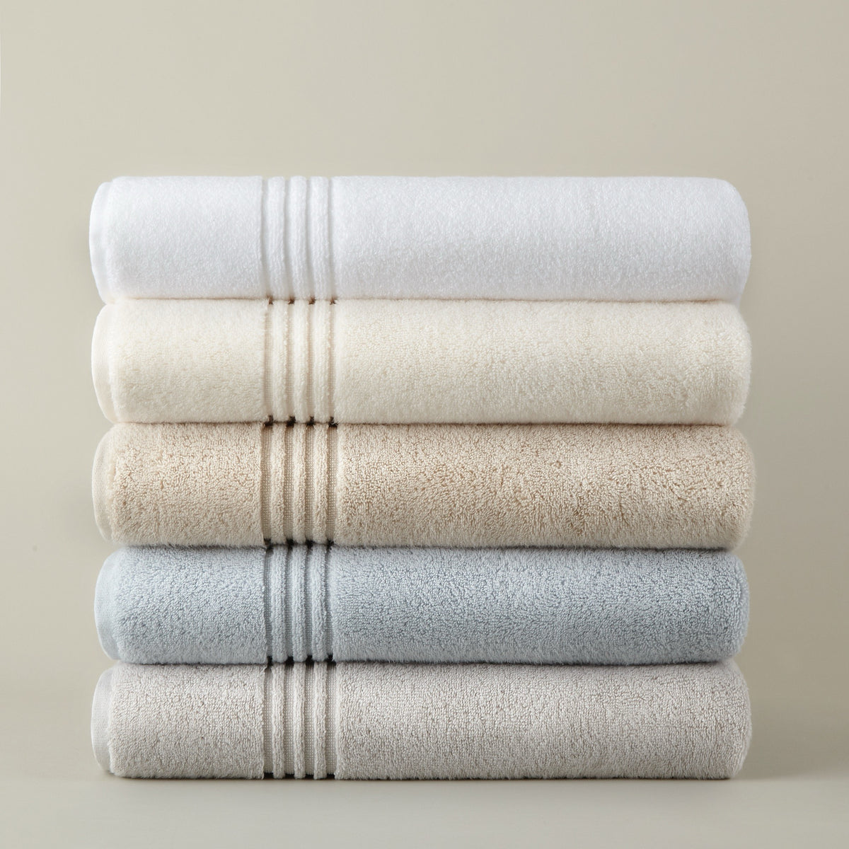 Stack of folded Peacock Alley Chelsea Bath Towels in different colors