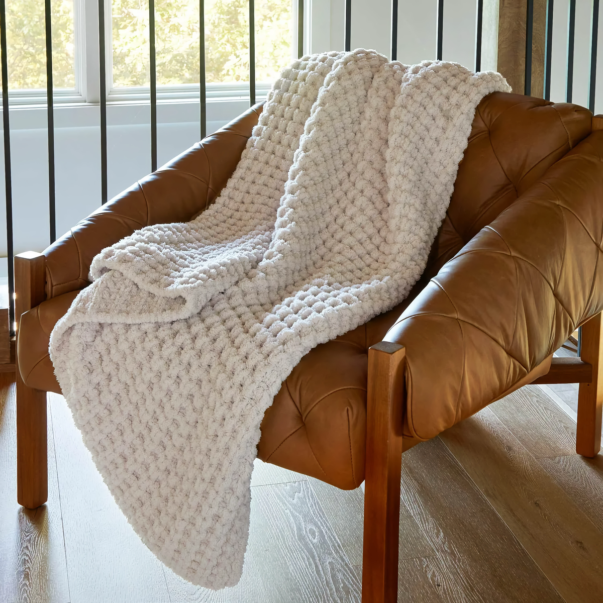 Lifestyle Photo of Peacock Alley Cozy Waffle Knit Throw in Linen