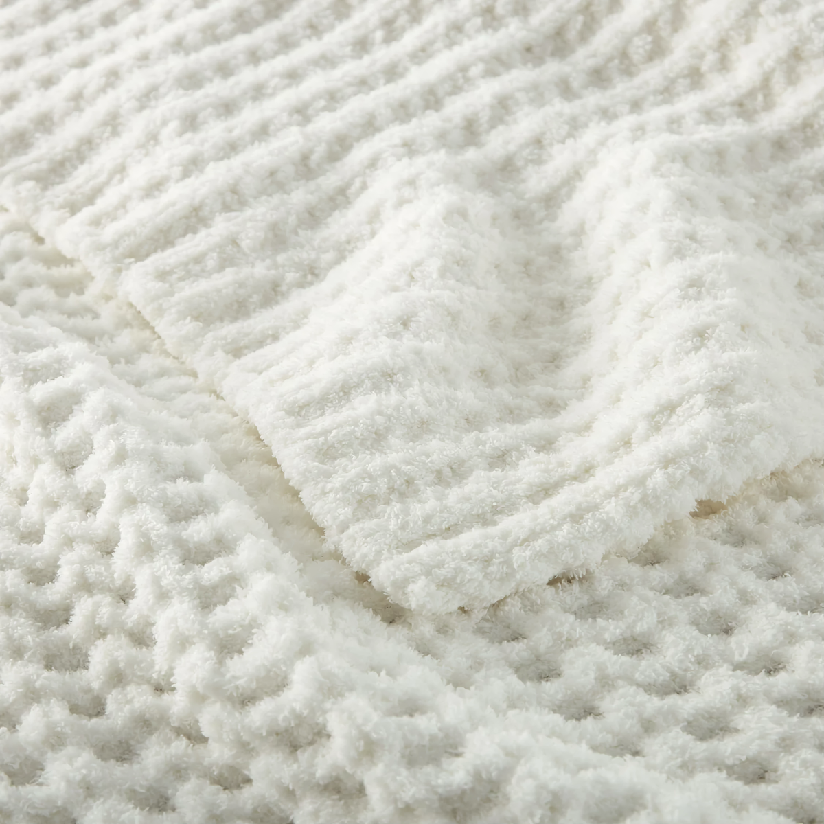 Closeup of Peacock Alley Cozy Waffle Knit Throw in White