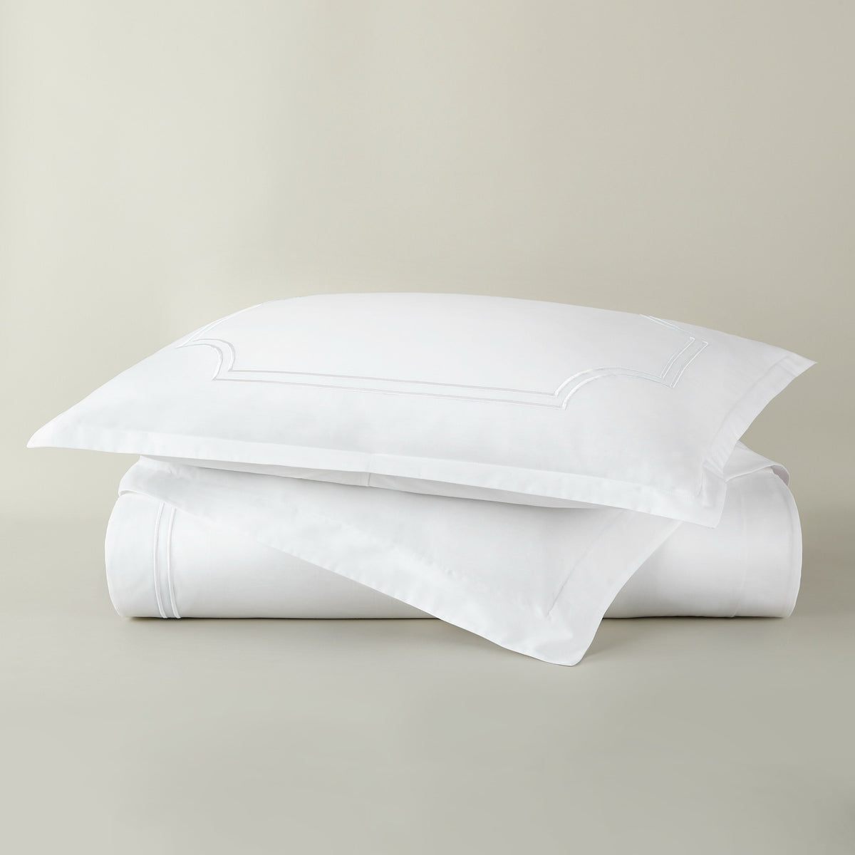 Stack of Peacock Alley Deco Classic Embroidered Duvet Set in White color