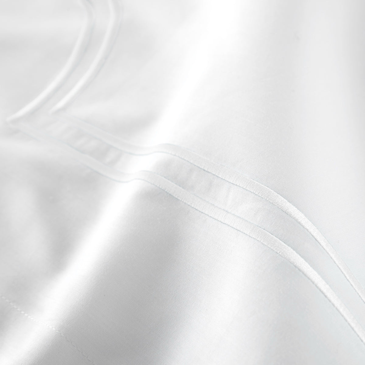 Fabric Closeup of White color Peacock Alley Deco Classic Embroidered Duvet Set