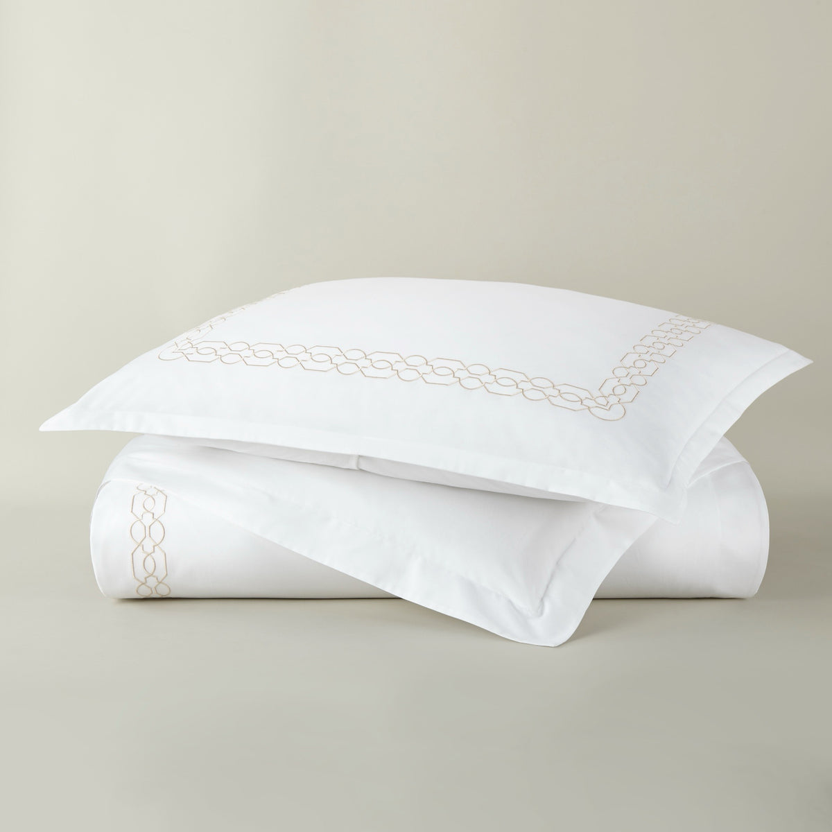 Stack of Peacock Alley Filigree Classic Embroidered Duvet Set in Linen color