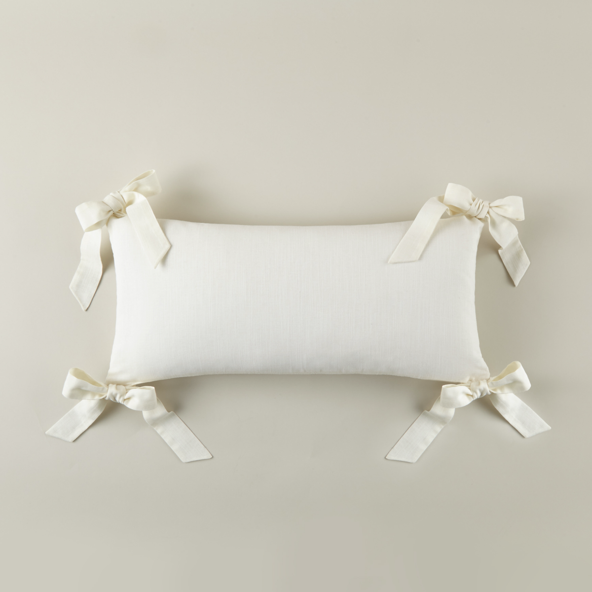 Pearl colored Peacock Alley Oblong Bow Pillow