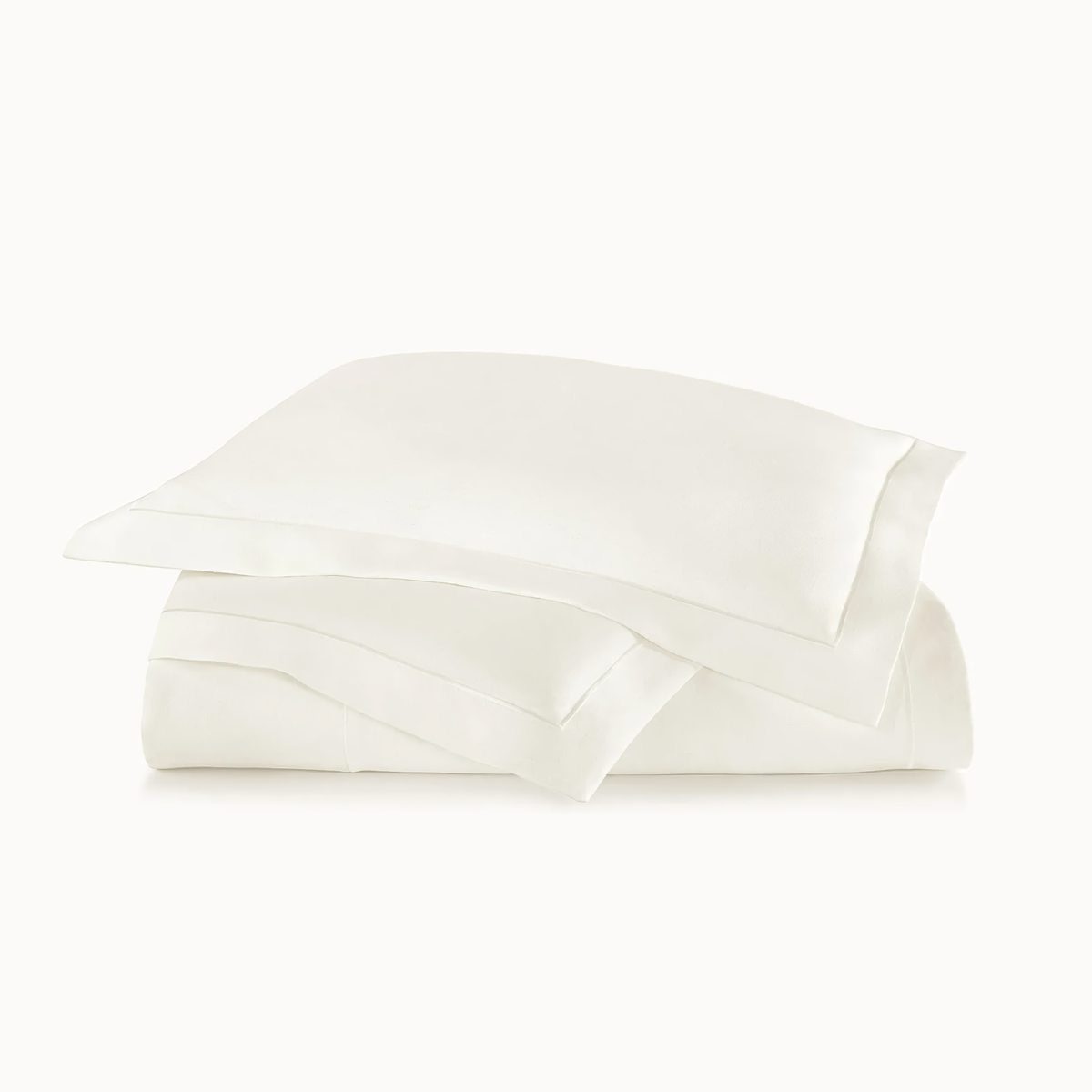Stack of Peacock Alley Rio Satin Stitch Bedding in Pearl