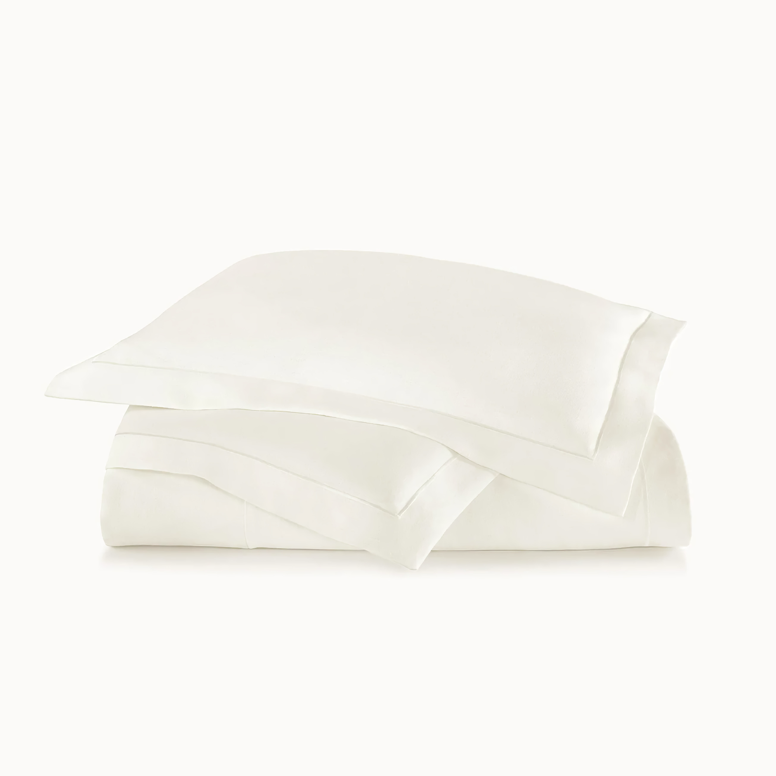 Stack of Peacock Alley Rio Satin Stitch Bedding in Pearl