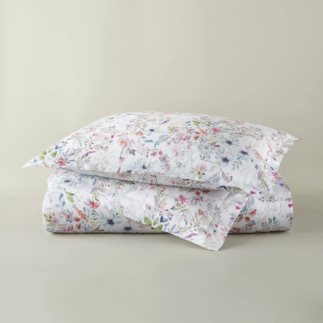 Floral patterned duvet and sham set on a plain background