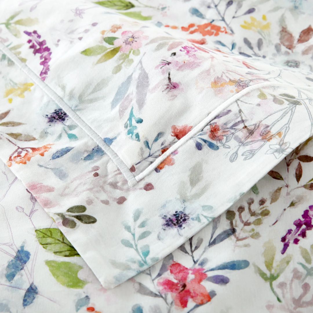 Floral patterned fabric with colorful flowers and leaves on a white background