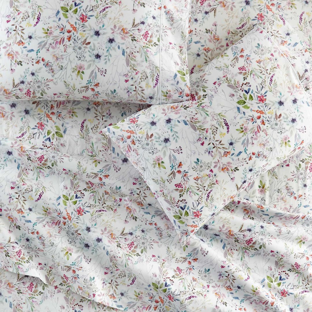 Floral patterned bedding set on a white background - pillowcases on a flat sheet