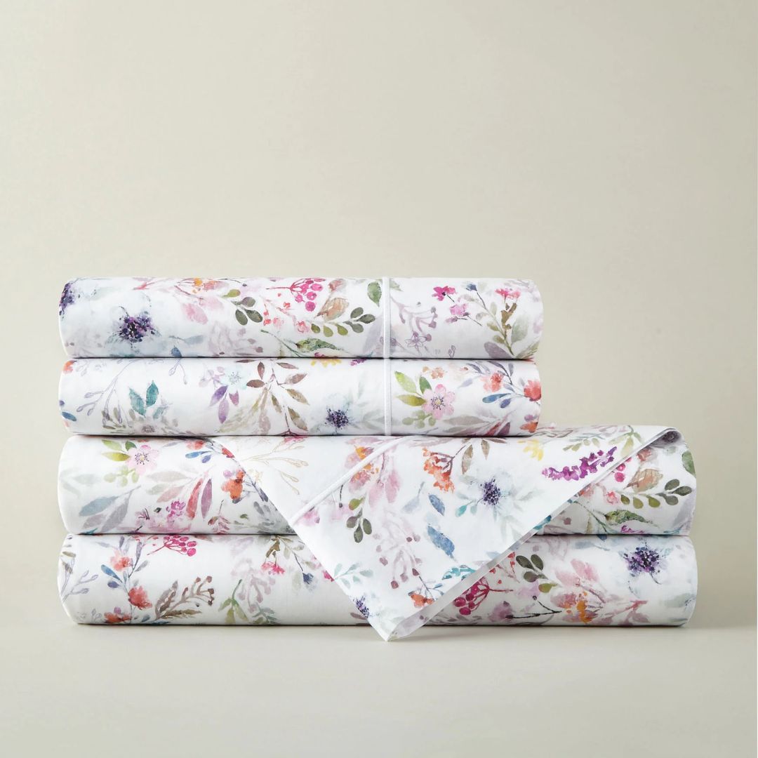 Stack of floral-patterned sheet set on a beige background