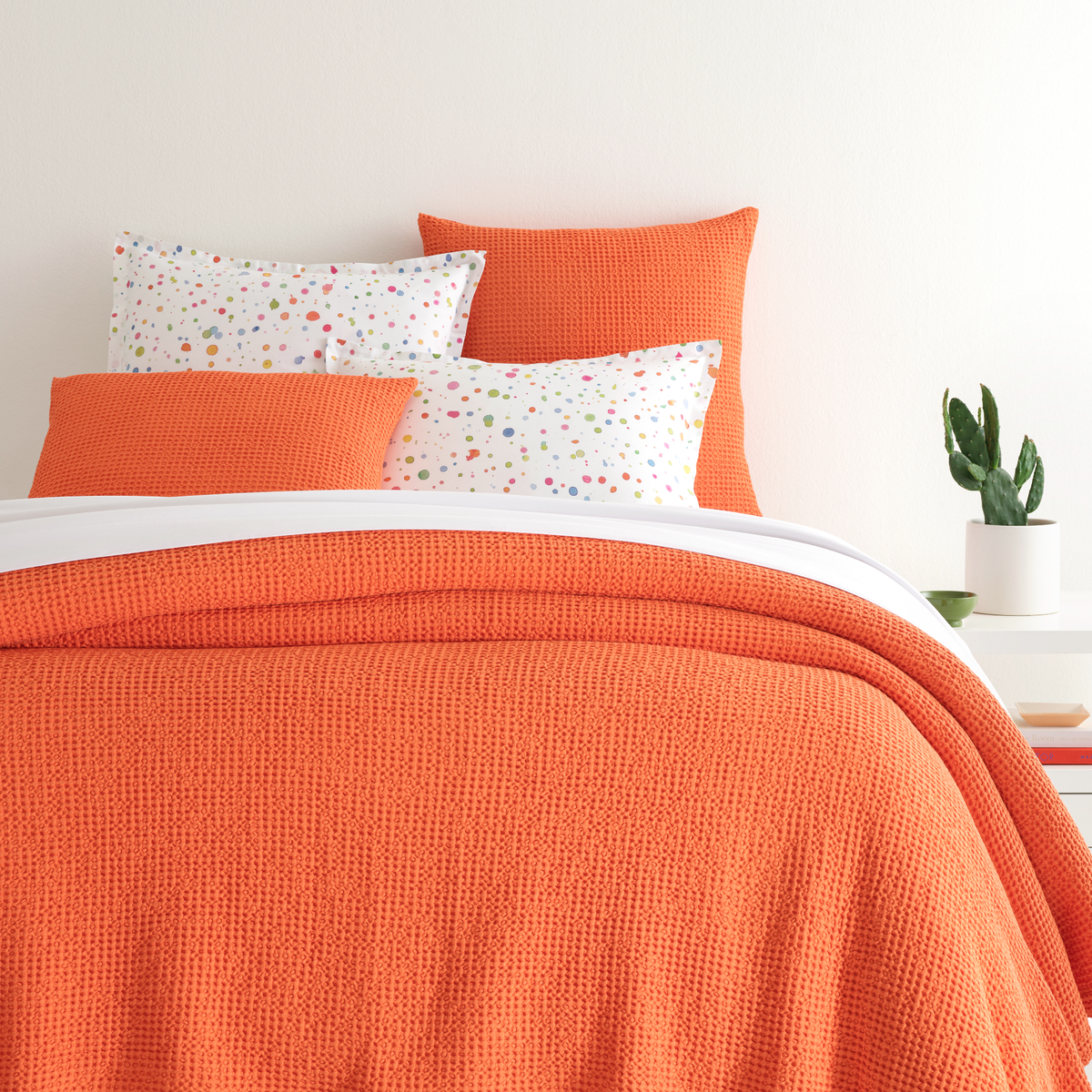 Closeup of Bed in Tangerine Pine Cone Hill Bubble Matelassé Coverlet &amp; Shams