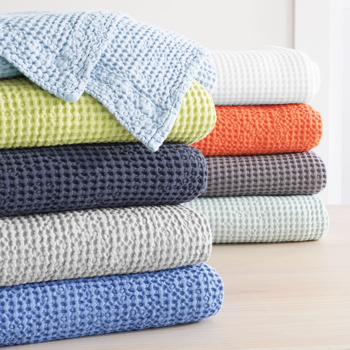 Stack of Different Colored Pine Cone Hill Bubble Matelassé Coverlets