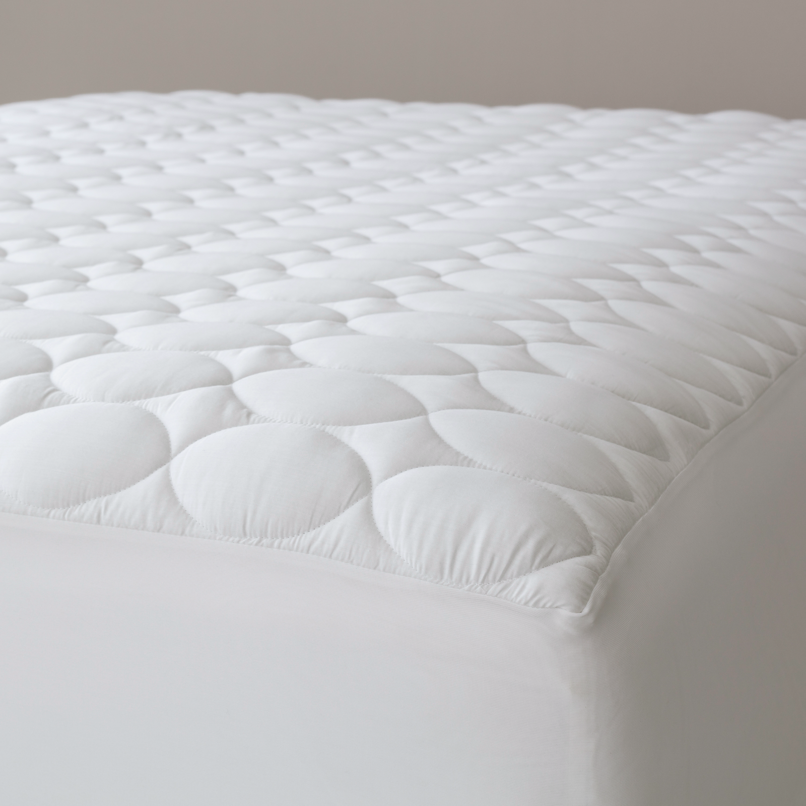 Pine Cone Hill Cloud Mattress Pad on a White Bed