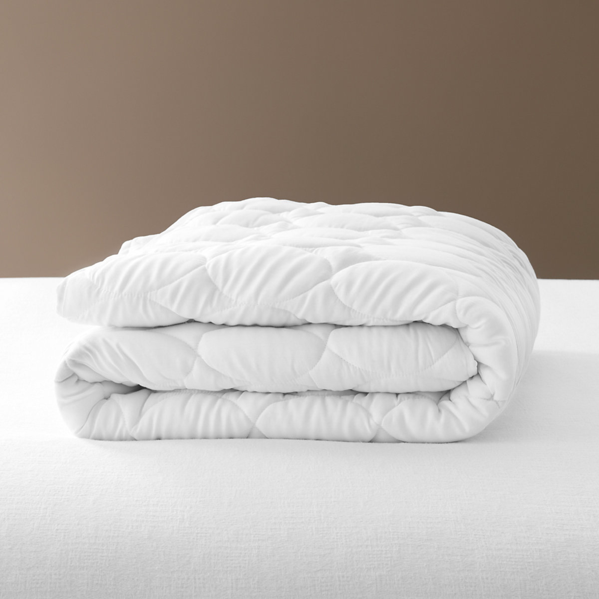 Pine Cone Hill Cloud Mattress Pad on a White Bed