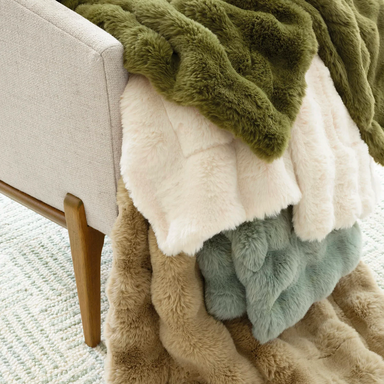 Stack of Pine Cone Hill Fab Faux Throws in all colors