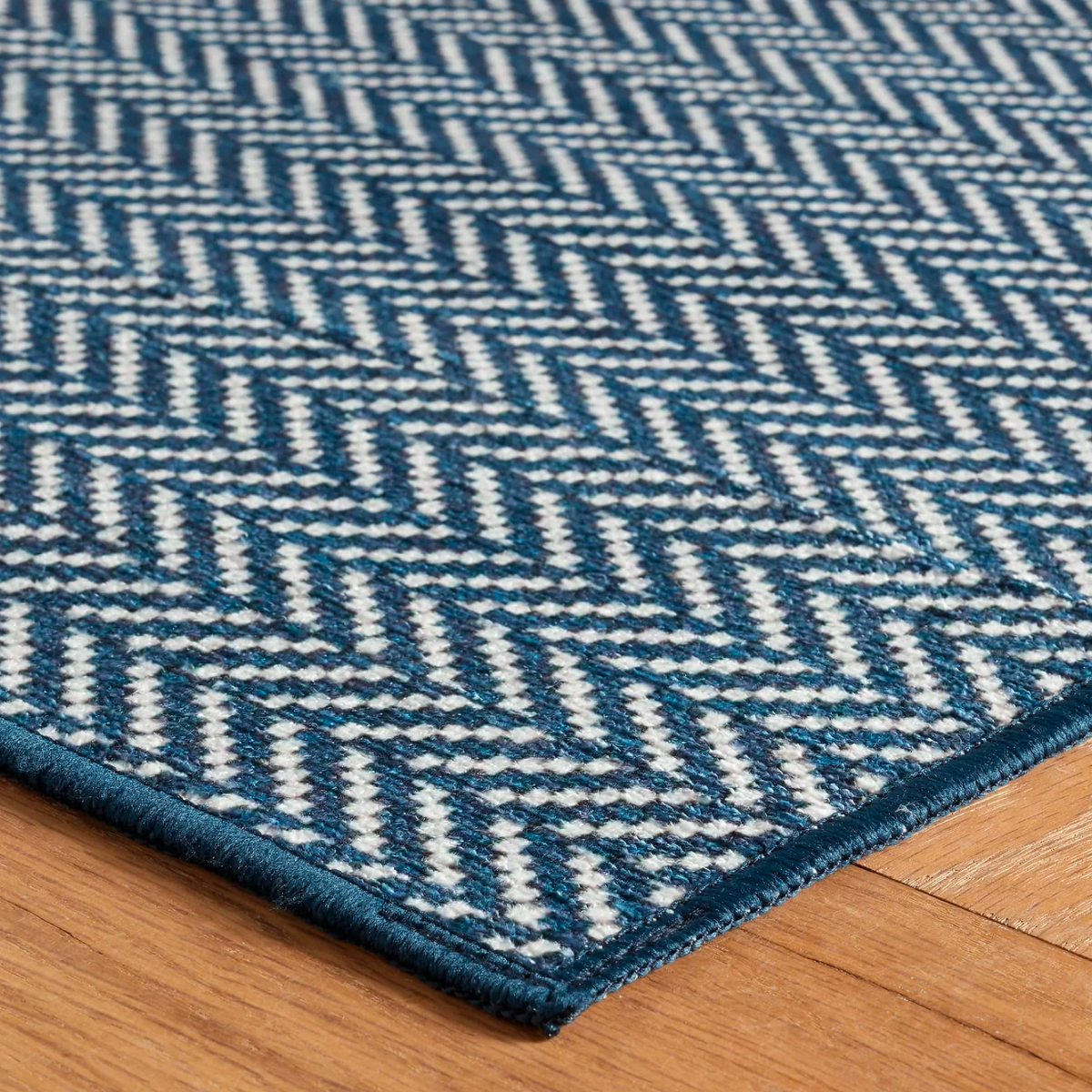 Corner of Navy Pine Cone Hill Herringbone Machine Washable Rug