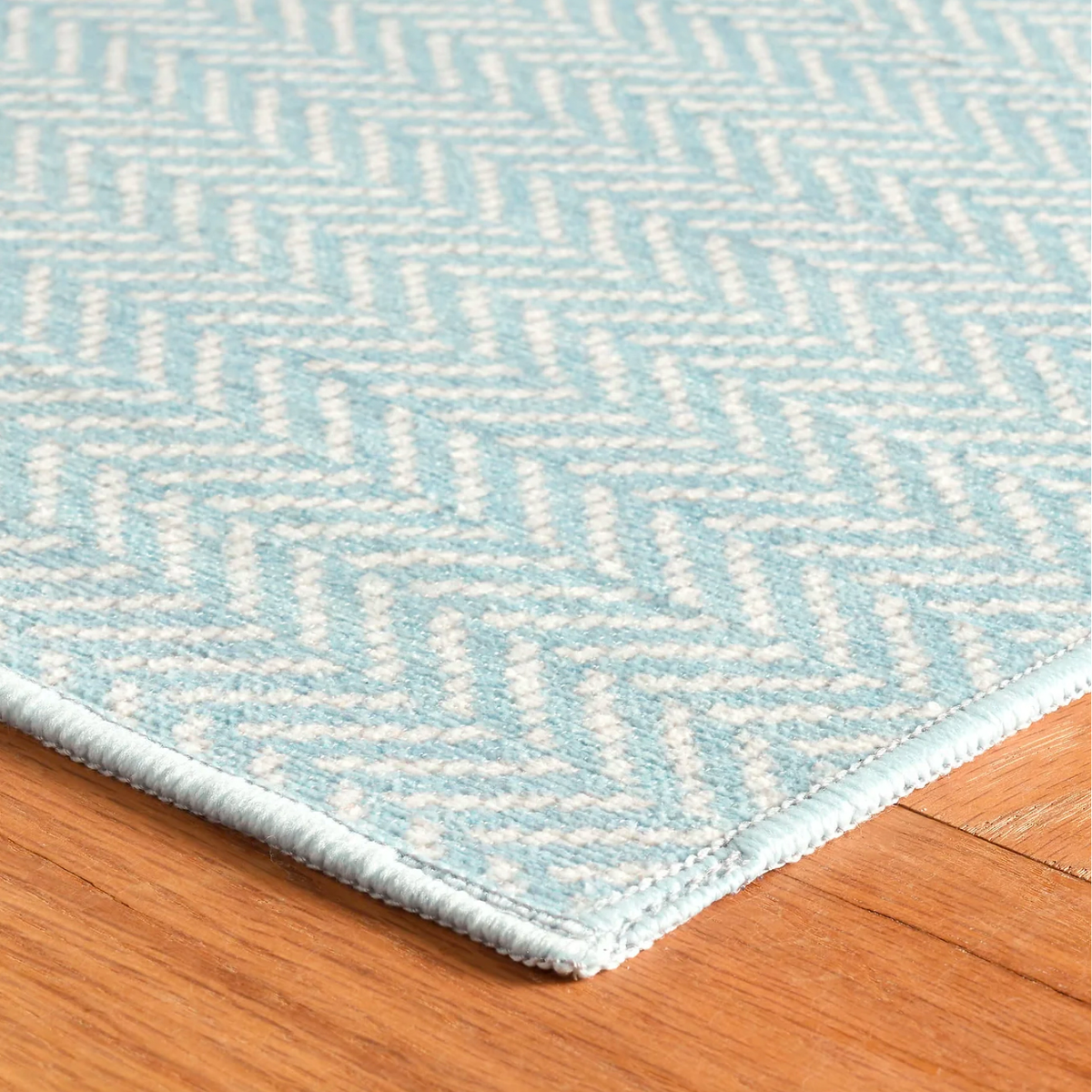 Corner of Swedish Blue Pine Cone Hill Herringbone Machine Washable Rug