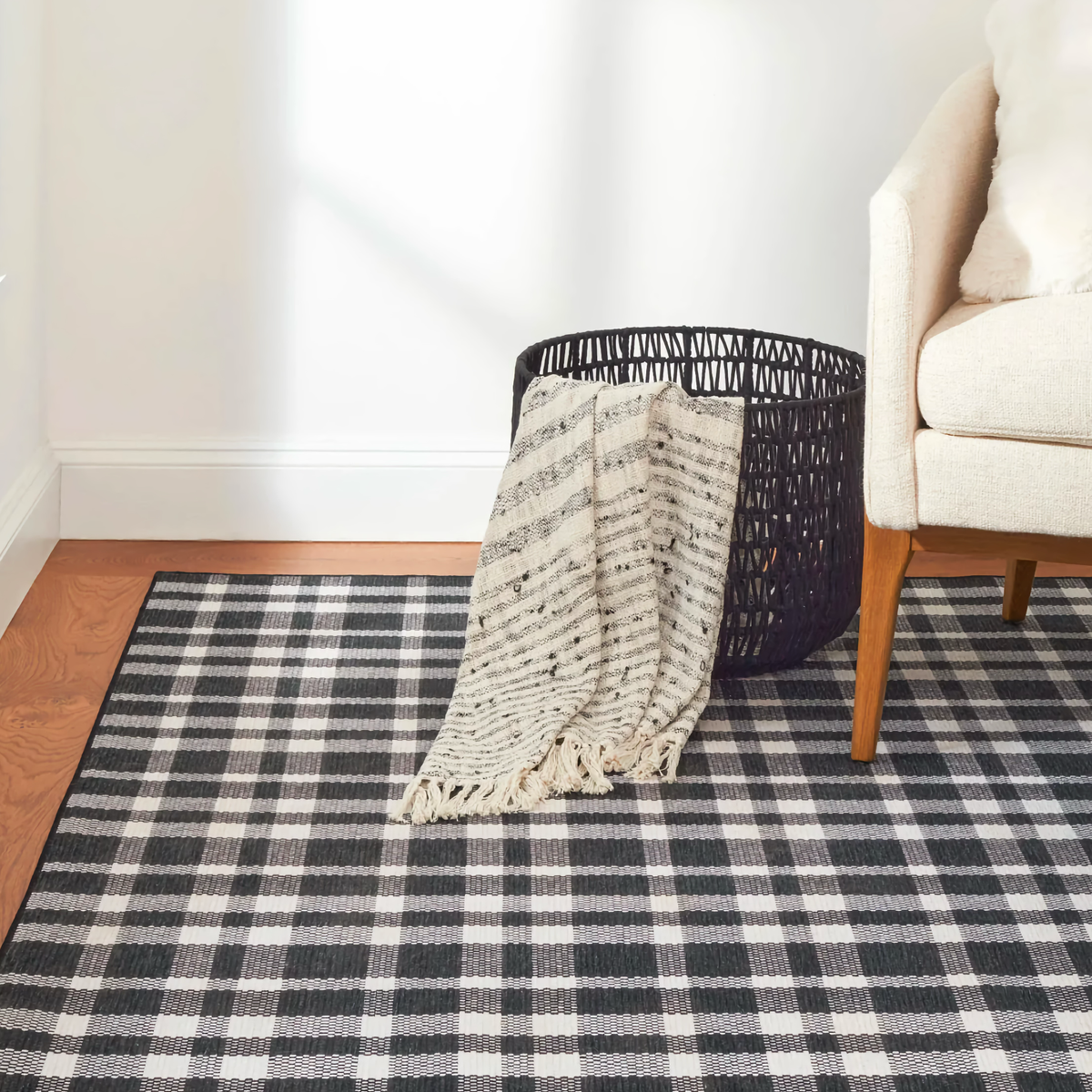 Pine Cone Hill Houston Plaid Machine Washable Rug in Black on Living room floor 