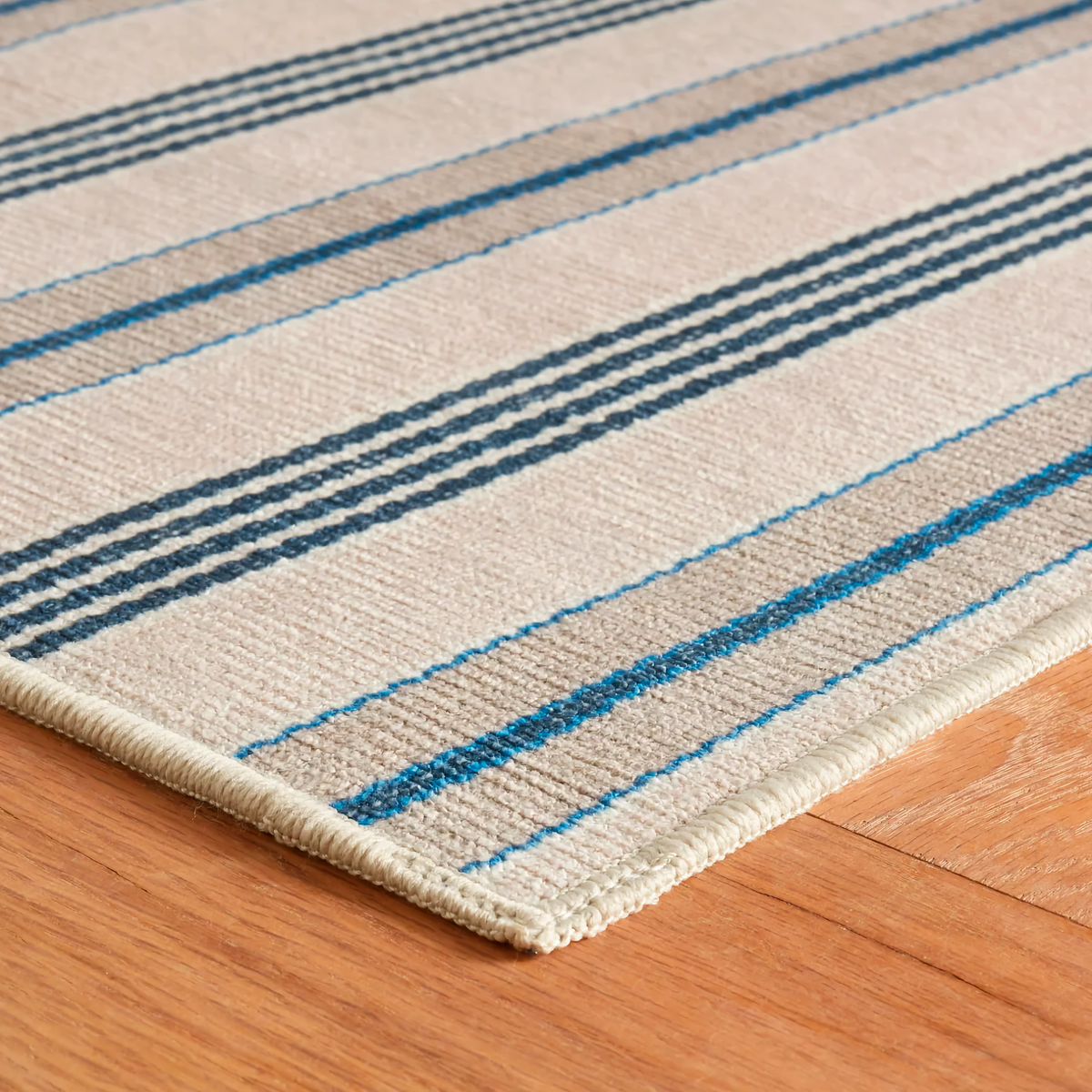 Corner of Neutral Pine Cone Hill Nimes Ticking Machine Washable Rug