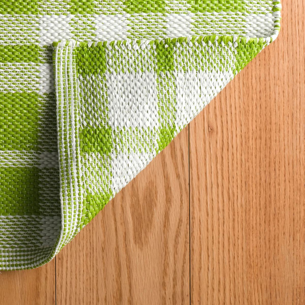 Corner Fold of Pine Cone Hill Tattersall Handwoven Indoor and Outdoor Rug in Sprout