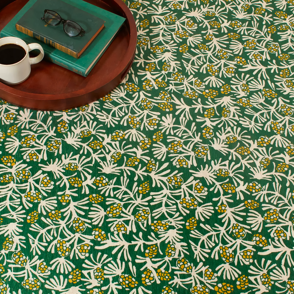 Closeup of Pine Cone Hill Winter Pinecones Machine Washable Rug in Green Color on the Floor