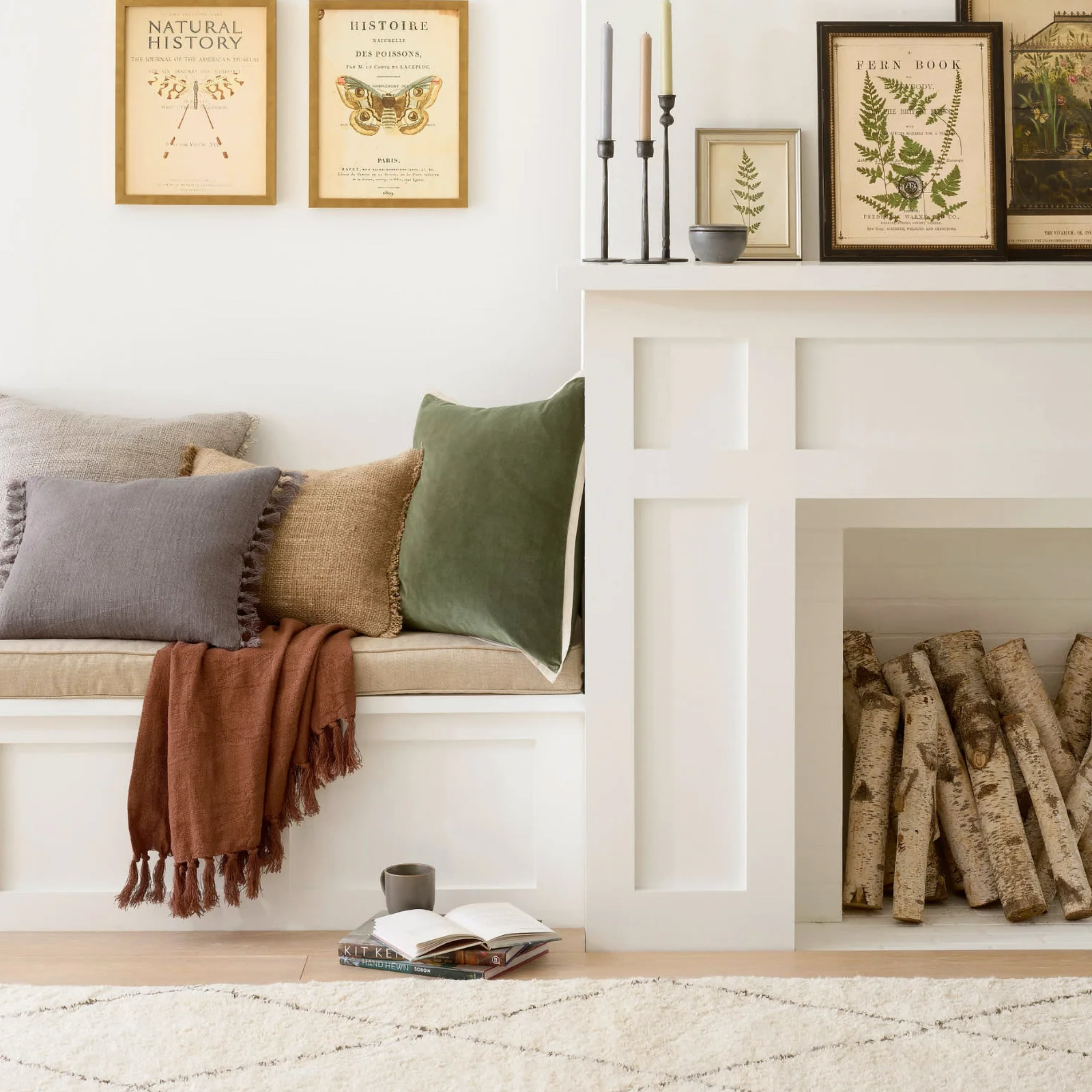 Pine Cone Hill Marie Flanagan Gehry Velvet/Linen Decorative Pillow in Sage near a fireplace