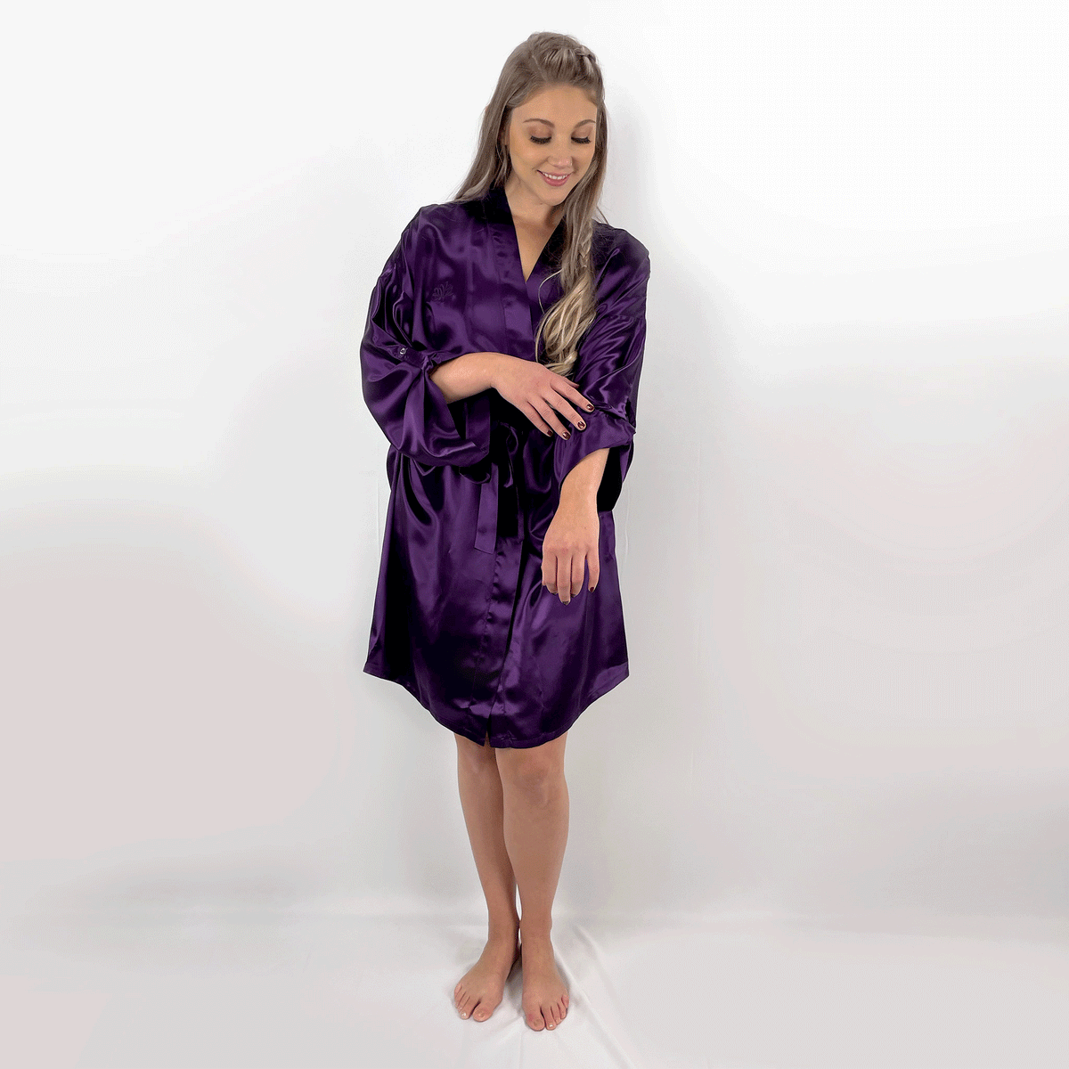 A model wearing a luxury robes for women, showcasing its soft texture from various angles in a GIF