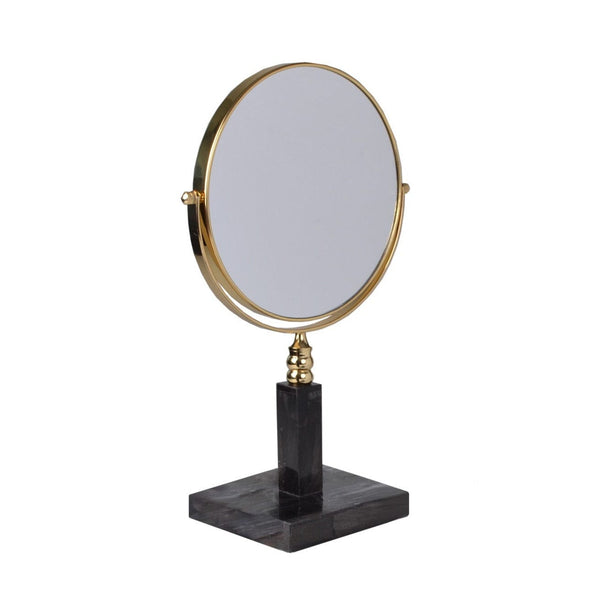 Round tabletop mirror with a gold frame, black marble base, and adjustable stand from the petrified wood collection.