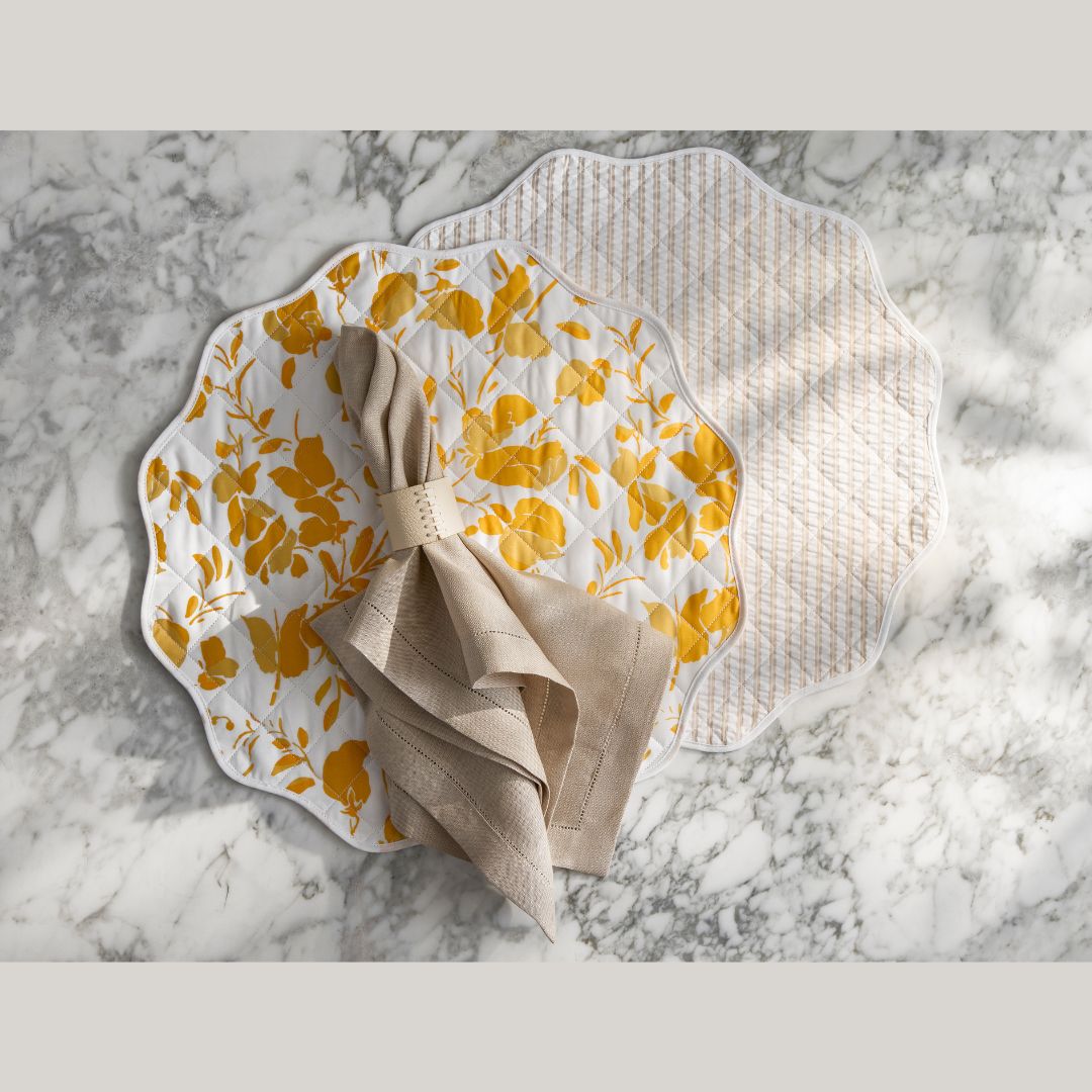 Reversible Placemat style Alexandra Goldenrod/Matteo Natural on a marble countertop with napkin in napkin ring on top of placemats