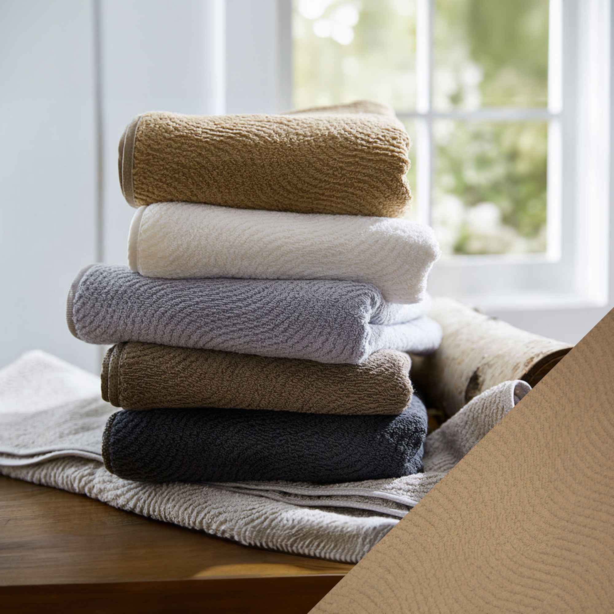 Stack of SDH Big Sur Bath Towels and Mats with Cognac Swatch