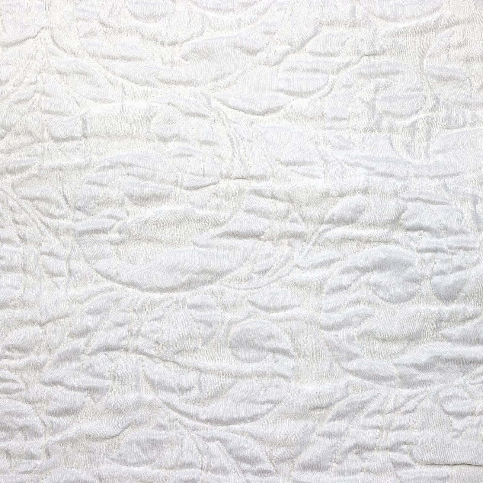 Jasmine Matelassé Snow coverlet on a bed