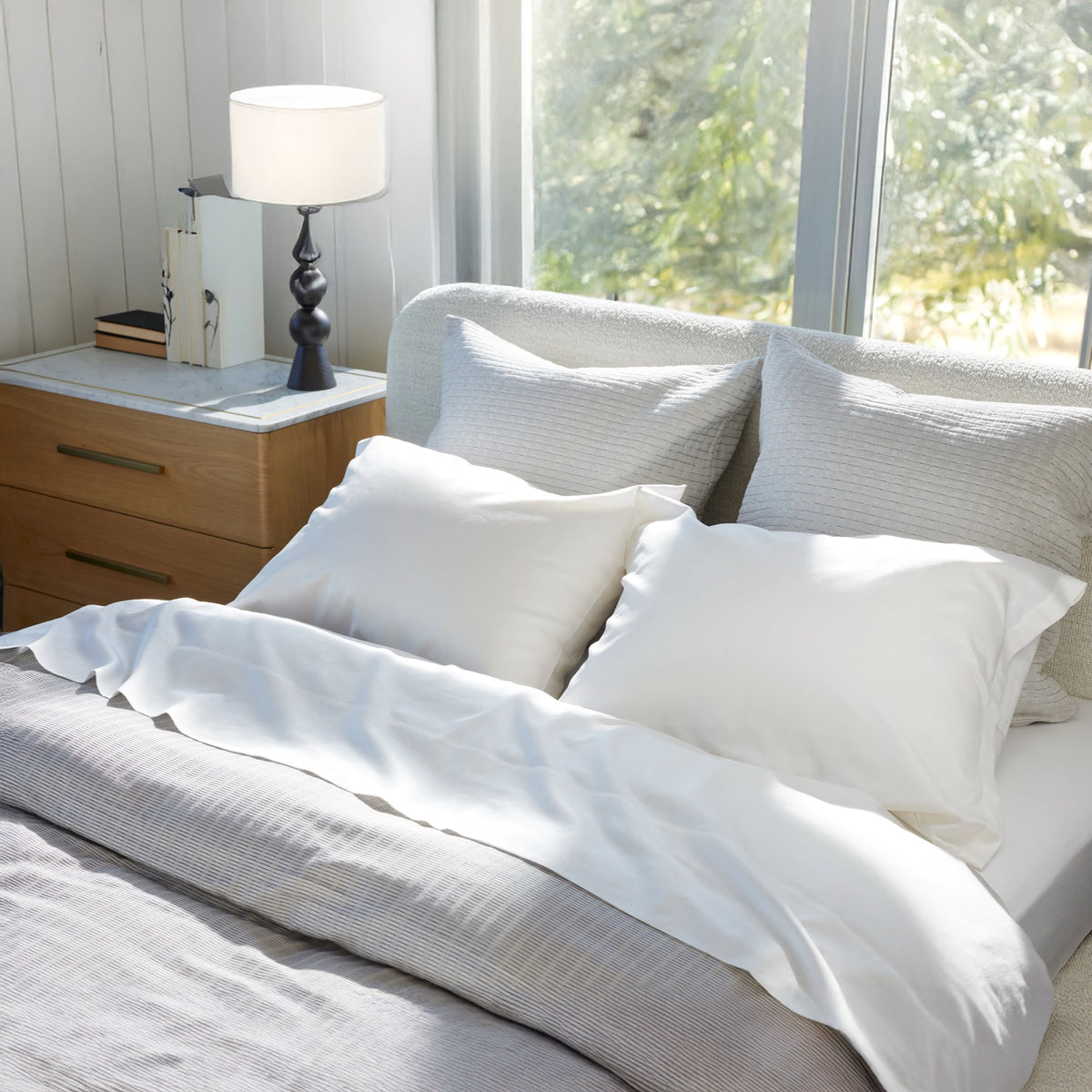 Patina Snow sheeting and standard pillows, Koji Driftwood european decorative pillows, and Kenji Driftwood duvet cover