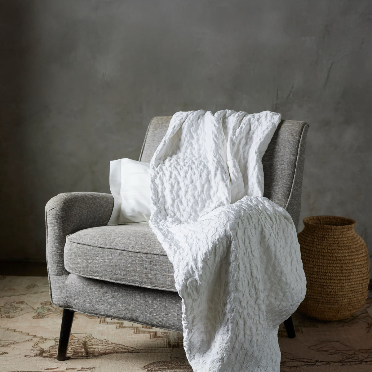 Snow SDH Petalo Bedding draped on a sofa