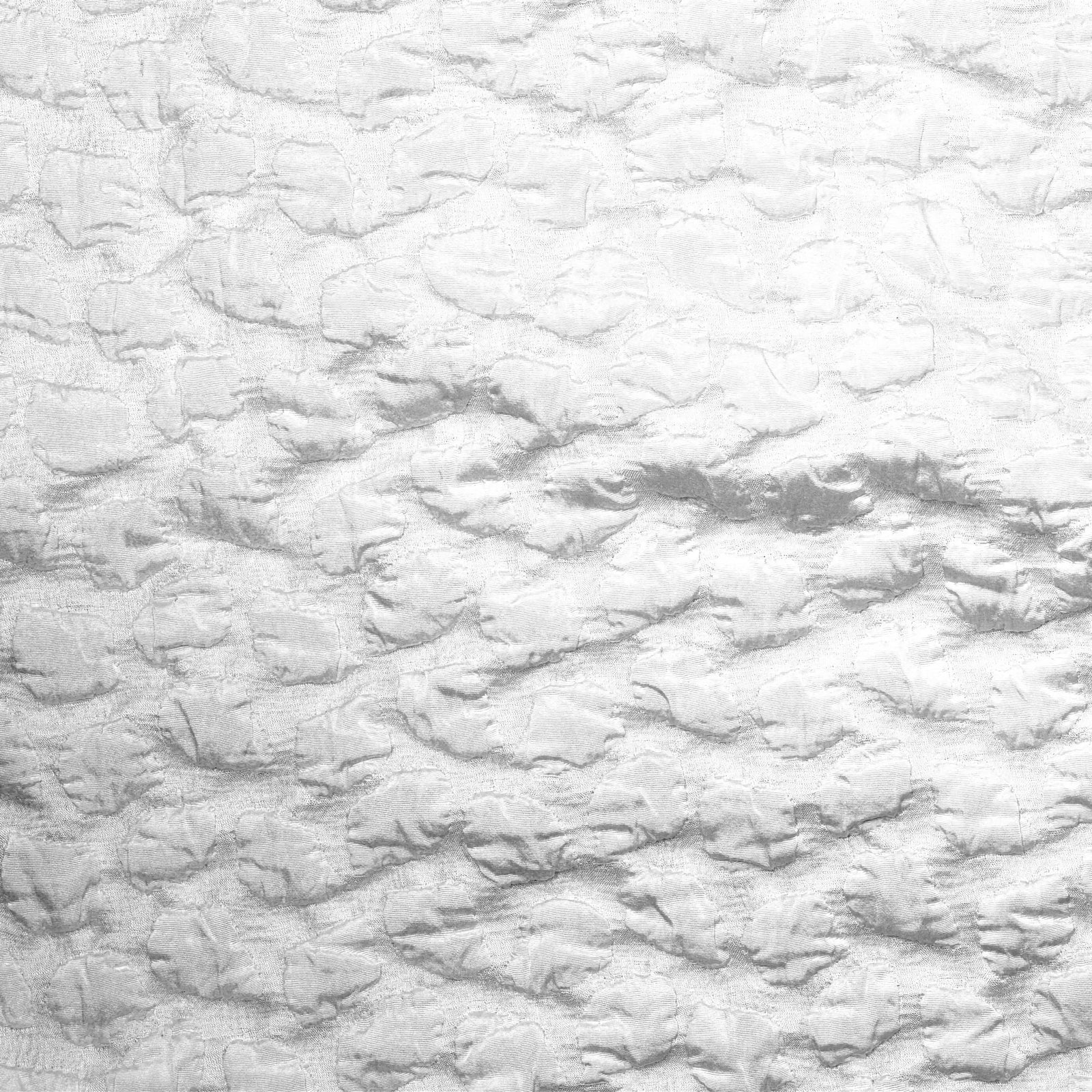 Snow SDH Petalo Bedding draped on a sofa