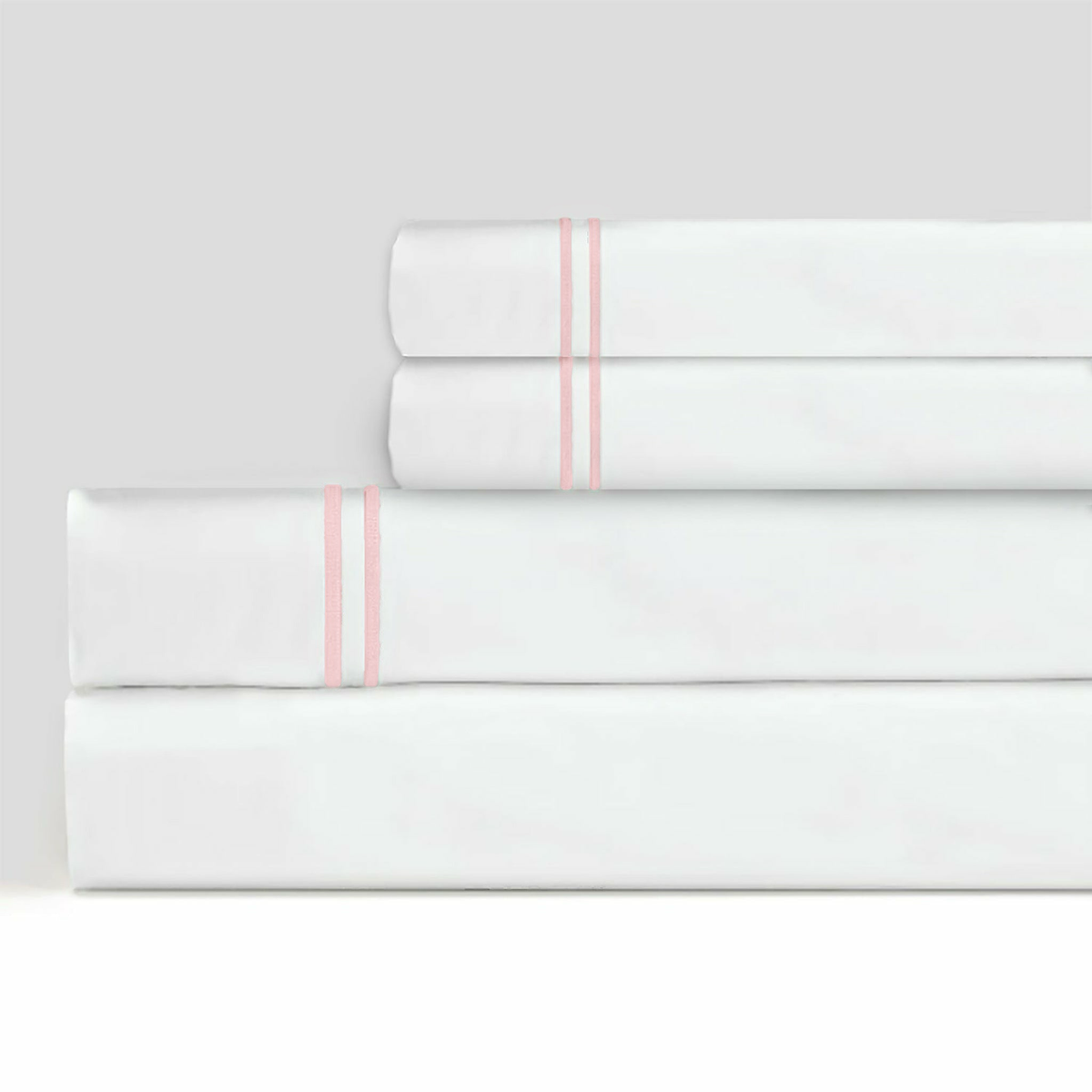 Stack of Sferra Grande Hotel Sheet Sets White/Pink