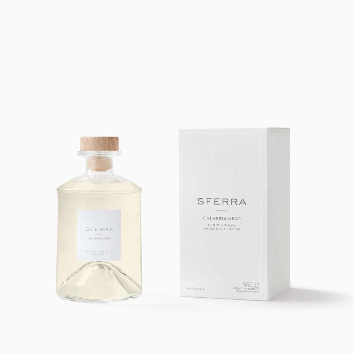Clear glass bottle with wooden cap, paired with Sferra Profumo di Casa—Calabria Nero scents in a sleek white box.